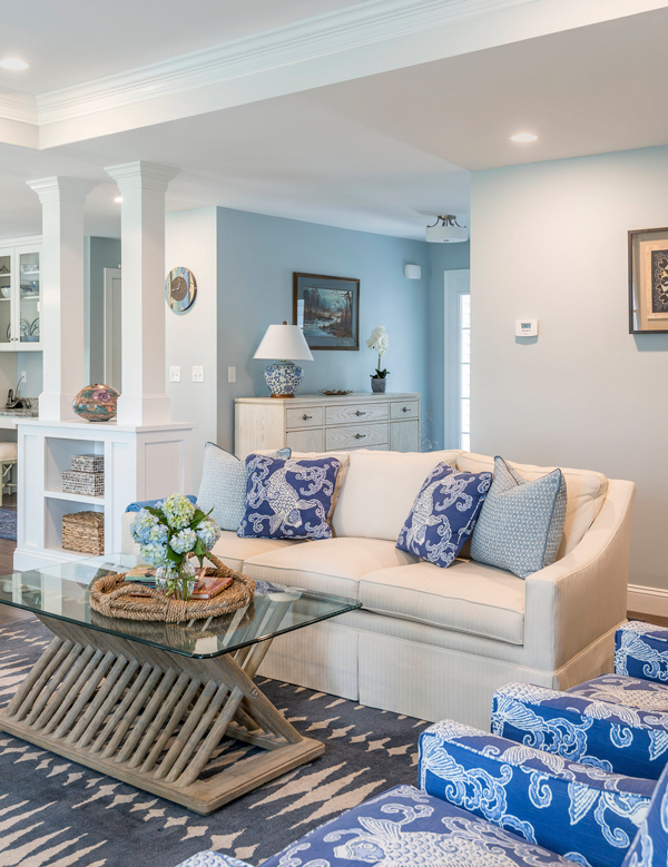 nautical themed living room with white couch and blue pillows